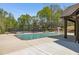 Community swimming pool with a clear blue water, surrounded by a sun deck, tennis court, and lush greenery at 4015 Two Bridge Ct, Buford, GA 30518