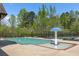 Community swimming pool with a mushroom fountain, surrounded by a sun deck, tennis court, and lush greenery at 4015 Two Bridge Ct, Buford, GA 30518