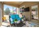 Relaxing sunroom with cushioned seating, open windows, and outdoor view at 4015 Two Bridge Ct, Buford, GA 30518