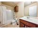Traditional bathroom featuring a shower-tub combo, toilet, vanity with countertop sink and cabinet at 6884 Barker Station Walk, Sugar Hill, GA 30518