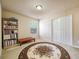 Bedroom with carpet, closet, one window, and bookshelf for storage and display at 6884 Barker Station Walk, Sugar Hill, GA 30518