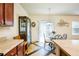 Cozy dining area with a glass-top table, decorative cabinet, and sliding glass doors for natural light at 6884 Barker Station Walk, Sugar Hill, GA 30518