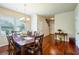 Formal dining room with a large wooden table, seating for six, and natural light from the window at 6884 Barker Station Walk, Sugar Hill, GA 30518
