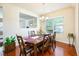 Cozy dining area featuring hardwood floors and a view into another room at 6884 Barker Station Walk, Sugar Hill, GA 30518