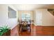 Elegant dining room with hardwood floors, stylish chandelier, and ample natural light at 6884 Barker Station Walk, Sugar Hill, GA 30518