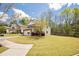 Charming two-story home with a well-manicured lawn, attached garage, and beautiful landscaping at 6884 Barker Station Walk, Sugar Hill, GA 30518