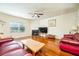 Spacious living room with hardwood floors, a cozy fireplace, and plenty of natural light at 6884 Barker Station Walk, Sugar Hill, GA 30518