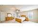 Bright main bedroom featuring a ceiling fan, large windows, and matching dressers at 6884 Barker Station Walk, Sugar Hill, GA 30518