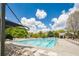 Community pool with plenty of lounge chairs, sunshades and nearby clubhouse at 6884 Barker Station Walk, Sugar Hill, GA 30518