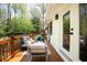 Cozy back deck featuring a seating area, wood floors, and privacy with the surrounding lush greenery at 1690 Cotswold Ne Dr, Brookhaven, GA 30319