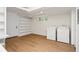 Basement laundry room with a washer and dryer, built-in shelving, wood-look flooring, and a white door at 1690 Cotswold Ne Dr, Brookhaven, GA 30319