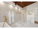 Bathroom features a soaking tub, glass enclosed shower, and tile flooring with a distinctive wood ceiling at 1690 Cotswold Ne Dr, Brookhaven, GA 30319