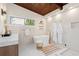 An expansive bathroom is appointed with a soaking tub under a window and a glass enclosed shower stall at 1690 Cotswold Ne Dr, Brookhaven, GA 30319