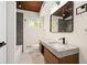 Bathroom features a floating vanity and a shower tub combo with gray marbled accents at 1690 Cotswold Ne Dr, Brookhaven, GA 30319