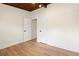 Neutral bedroom with wood floor and wood beam ceiling with two doors and a window for natural light at 1690 Cotswold Ne Dr, Brookhaven, GA 30319