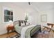 Well-lit bedroom with hardwood floors, a large window, and a bed with decorative throw pillows at 1690 Cotswold Ne Dr, Brookhaven, GA 30319