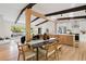Bright dining area showcasing an open floorplan with modern kitchen and hardwood floors throughout the living spaces at 1690 Cotswold Ne Dr, Brookhaven, GA 30319