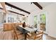 Inviting dining area with wooden beams and a seamless transition to a modern kitchen with stainless steel appliances at 1690 Cotswold Ne Dr, Brookhaven, GA 30319