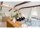 Open living area featuring wood beam ceiling, comfortable furniture, and a view into the kitchen at 1690 Cotswold Ne Dr, Brookhaven, GA 30319