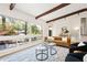 Sunlit living room with large windows, stylish seating, and natural light at 1690 Cotswold Ne Dr, Brookhaven, GA 30319