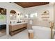Luxurious main bathroom features a double vanity, soaking tub, and stylish fixtures with modern design at 1690 Cotswold Ne Dr, Brookhaven, GA 30319