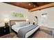 Inviting main bedroom featuring a dark wood-paneled ceiling, hardwood floors, and ensuite bathroom at 1690 Cotswold Ne Dr, Brookhaven, GA 30319