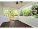 Screened porch with wood flooring overlooking a wooded area with white trim and natural light at 1690 Cotswold Ne Dr, Brookhaven, GA 30319