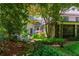 Secluded backyard with seating area, mature trees, and manicured landscaping at 2167 W Wesley Nw Rd, Atlanta, GA 30327