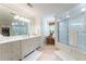 Bright bathroom with a shower, a bathtub, dual sinks, and marble countertops at 2167 W Wesley Nw Rd, Atlanta, GA 30327