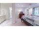 Bedroom and en-suite bathroom with matching tiled floors, a vintage dresser and ample light at 2167 W Wesley Nw Rd, Atlanta, GA 30327