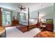 Bright bedroom with french doors, four-poster bed, and hardwood floors at 2167 W Wesley Nw Rd, Atlanta, GA 30327