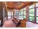 Charming dining area featuring a wooden table, bench seating, and ample natural light from surrounding windows at 2167 W Wesley Nw Rd, Atlanta, GA 30327
