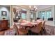 Elegant dining room with chandelier, large window and view to outdoor, and view to the fireplace in the living room at 2167 W Wesley Nw Rd, Atlanta, GA 30327