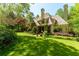 Stunning exterior of home with lush landscaping, shingle roof, and stone accents at 2167 W Wesley Nw Rd, Atlanta, GA 30327