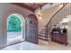 Grand foyer featuring an arched entryway, elegant staircase, and antique furnishings at 2167 W Wesley Nw Rd, Atlanta, GA 30327