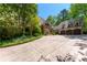 Beautiful exterior with stone accents, three car garage, and meticulously landscaped grounds at 2167 W Wesley Nw Rd, Atlanta, GA 30327
