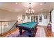 Elegant game room features a pool table, hardwood floors, and a stylish chandelier at 2167 W Wesley Nw Rd, Atlanta, GA 30327
