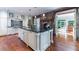 Spacious kitchen with a central island, stone fireplace, custom cabinetry, and hardwood floors at 2167 W Wesley Nw Rd, Atlanta, GA 30327