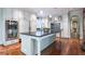 Bright kitchen features stainless appliances, large island with black countertop and dark hardwood floors at 2167 W Wesley Nw Rd, Atlanta, GA 30327
