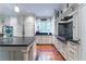 Well-appointed kitchen with a center island, stainless steel appliances, custom cabinetry, and hardwood floors at 2167 W Wesley Nw Rd, Atlanta, GA 30327