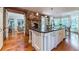 Gourmet kitchen with a large center island, stone fireplace, granite countertops, and hardwood floors at 2167 W Wesley Nw Rd, Atlanta, GA 30327