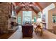 Inviting living room with a stone fireplace, vaulted ceilings, exposed beams, and large windows at 2167 W Wesley Nw Rd, Atlanta, GA 30327