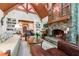 Comfortable living room featuring a stone fireplace, vaulted ceiling with wood beams, and built in bookshelves at 2167 W Wesley Nw Rd, Atlanta, GA 30327