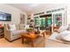 Open-concept living room with sliding glass doors to patio, neutral decor, and hardwood floors at 2167 W Wesley Nw Rd, Atlanta, GA 30327