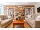 Living room features stone fireplace and exposed wood beams at 2167 W Wesley Nw Rd, Atlanta, GA 30327