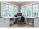 Bright office space with built-in desk, cabinetry, and a large window overlooking the trees at 2167 W Wesley Nw Rd, Atlanta, GA 30327