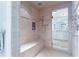 Luxurious walk-in shower featuring beautiful tile work, a bench, and glass door to an adjacent vanity at 2167 W Wesley Nw Rd, Atlanta, GA 30327