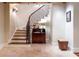Elegant staircase with wooden steps, iron railing, and travertine tile floors leading to the upper level at 2167 W Wesley Nw Rd, Atlanta, GA 30327