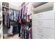 Well-organized walk-in closet with hanging rods and white drawers for storing clothing and accessories at 2167 W Wesley Nw Rd, Atlanta, GA 30327