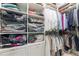 Organized walk-in closet with wire baskets, rods for hanging, and shelves for neatly folded items at 2167 W Wesley Nw Rd, Atlanta, GA 30327